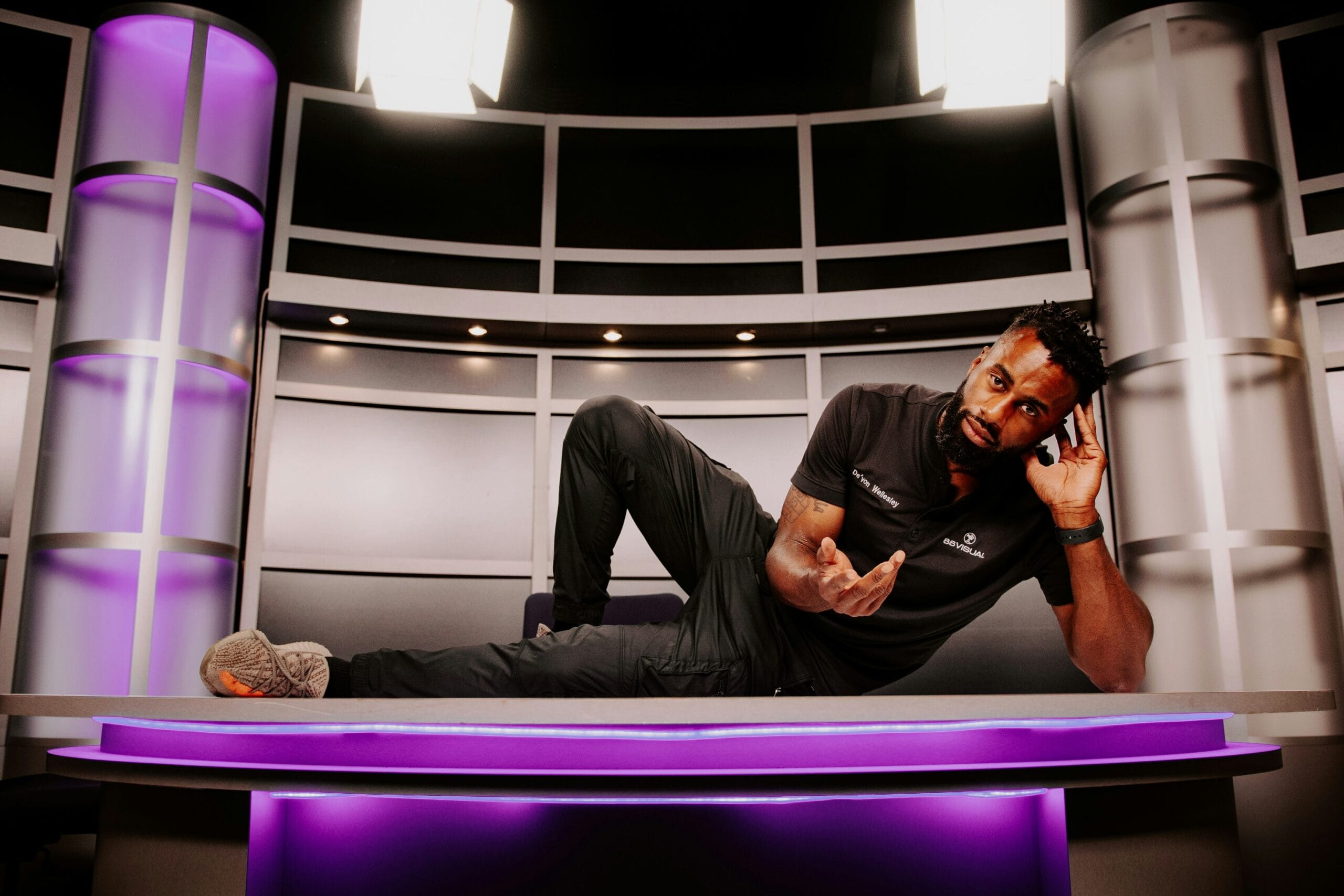 a man laying on a table talking on a cell phone