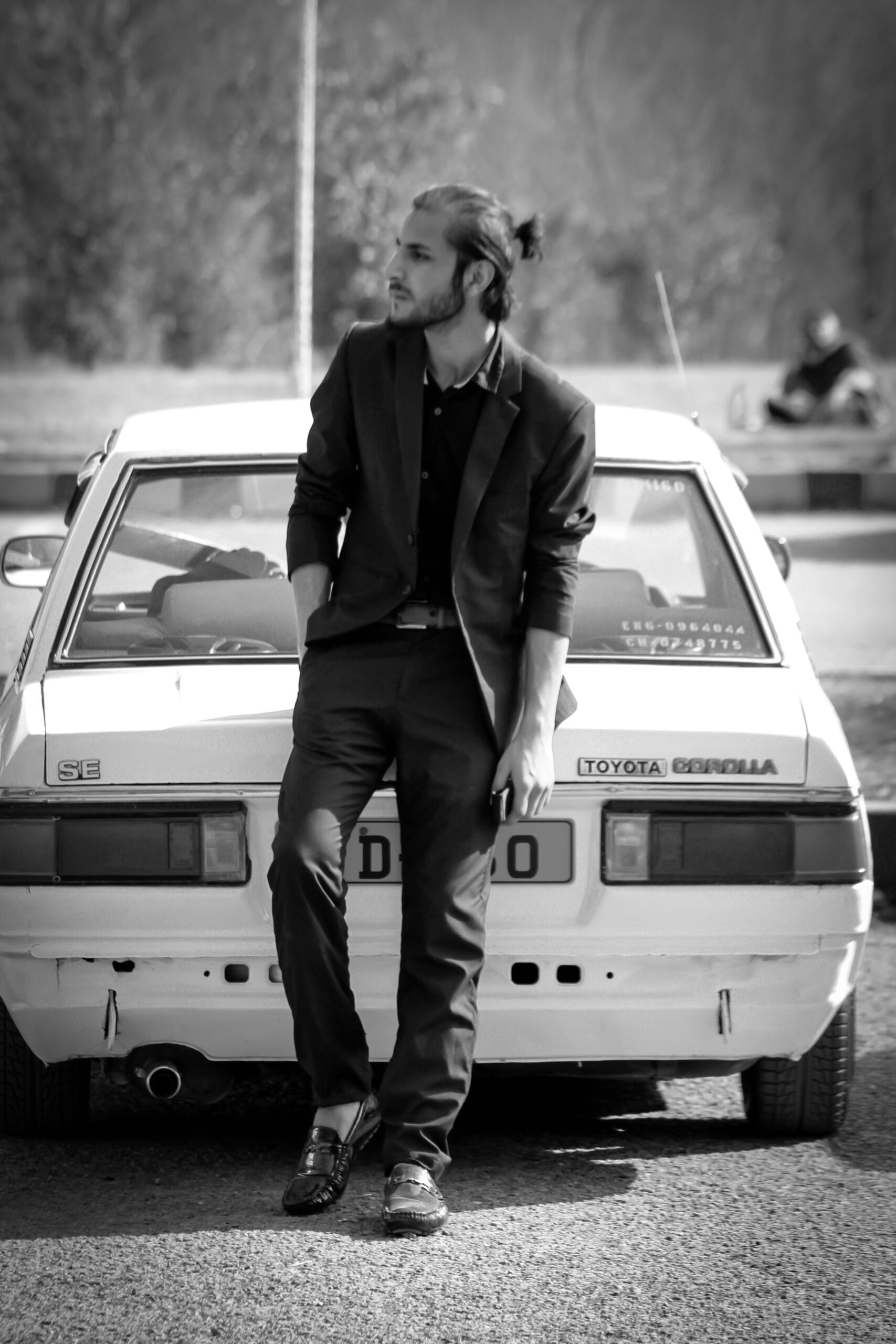 a man sitting on the hood of a car